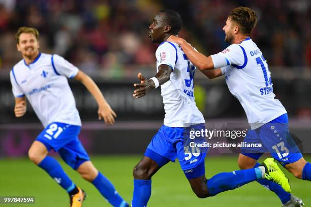 Darmstadt's Wilson Kamavuaka celebrates his goal with his teammates Markus Steinhoefer and Immanuel Hoehn during the German 2nd Bundesliga soccer...