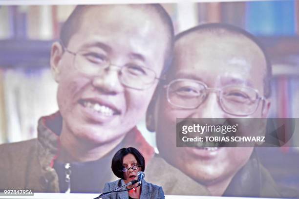 The late Chinese dissident and Nobel Peace Prize laureate Liu Xiaobo and his widow Liu Xia are seen on the screen as Nobel laureate Herta Mueller...