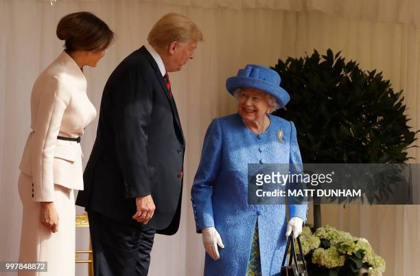 Britain's Queen Elizabeth II talks with US President Donald Trump and US First Lady Melania Trump on the dias in the Quadrangle during a welcome...