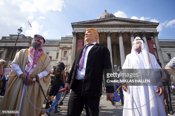 Protesters against the UK visit of US President Donald Trump gather in Trafalgar Square after taking part in a march in London on July 13, 2018. -...