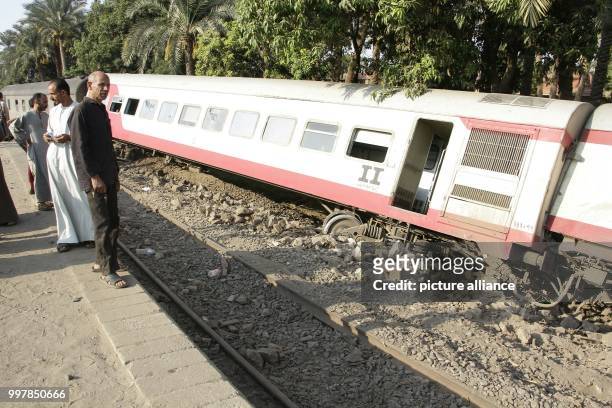 People gather at the scene where a train derailed near Badrasheen, Giza, Egypt, 13 July 2018. At least 55 people were injured as a Health Ministry...