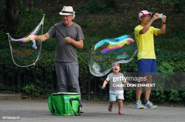 People enjoy a summer day in Central Park July 13, 2018 in New York.