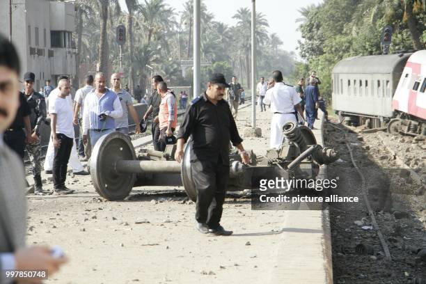 Police officer stands at the scene where a passenger train derailed near Badrasheen, Giza, Egypt, 13 July 2018. At least 55 people were injured as a...