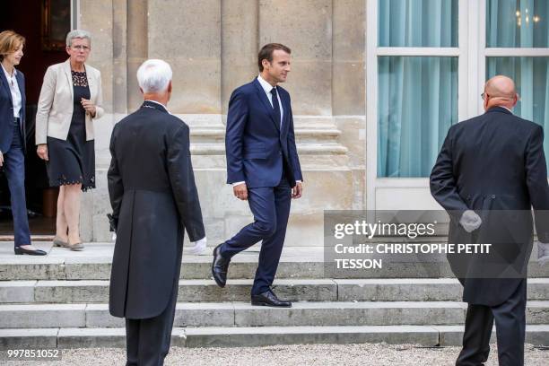 French President Emmanuel Macron , and French Defense Minister Florence Parly , arrives to deliver a speech after signing the annual armed forces...