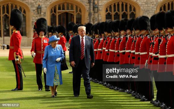 President Donald Trump and Britain's Queen Elizabeth II inspect a Guard of Honour, formed of the Coldstream Guards at Windsor Castle on July 13, 2018...