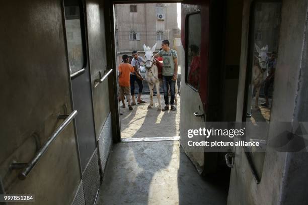 People gather at the scene where a passenger train derailed near Badrasheen, Giza, Egypt, 13 July 2018. At least 55 people were injured as a Health...