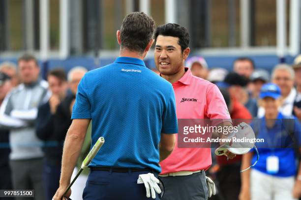 Justin Rose of England talks with Hideki Matsuyama of Japan on hole eighteen during day two of the Aberdeen Standard Investments Scottish Open at...