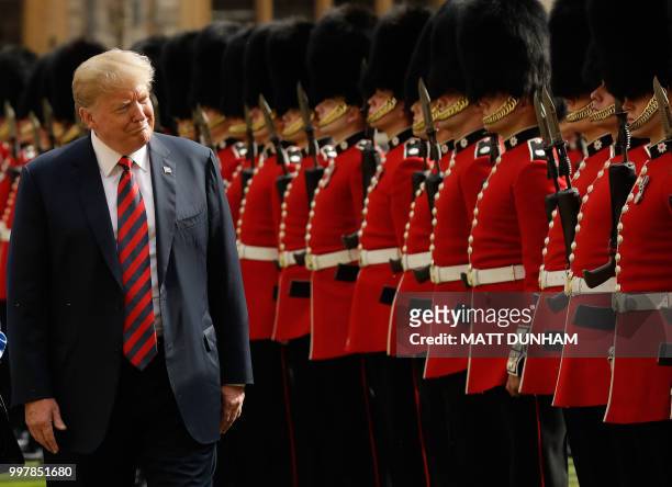 President Donald Trump inspects the guard of honour formed of the Coldstream Guards during a welcome ceremony at Windsor Castle in Windsor, west of...