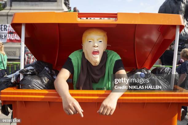 Protesters against the UK visit of US President Donald Trump gather in Trafalgar Square after taking part in a march in London on July 13, 2018. -...