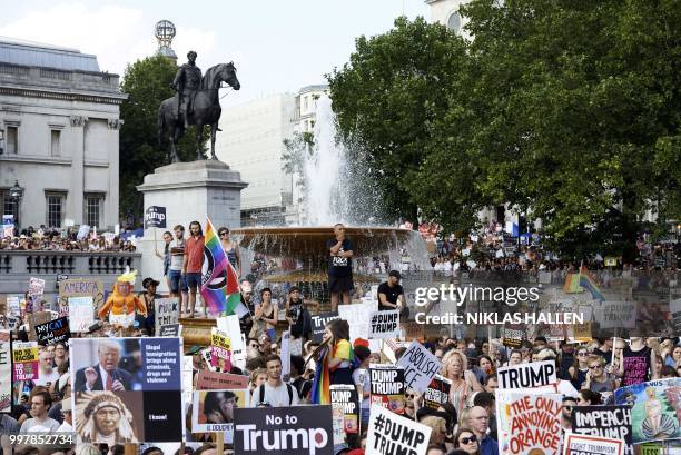 Protesters against the UK visit of US President Donald Trump gather in Trafalgar Square after taking part in a march in London on July 13, 2018. -...