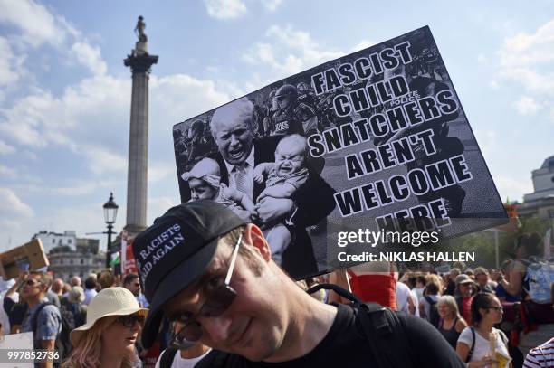 Protesters against the UK visit of US President Donald Trump gather in Trafalgar Square after taking part in a march in London on July 13, 2018. -...