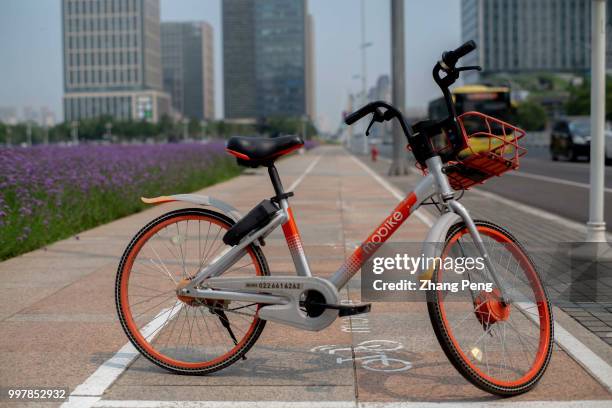 Mobike bicycle stops on the special parking area at roadside. On July 5th, Mobike company announced that all users in China would ride the mobike...