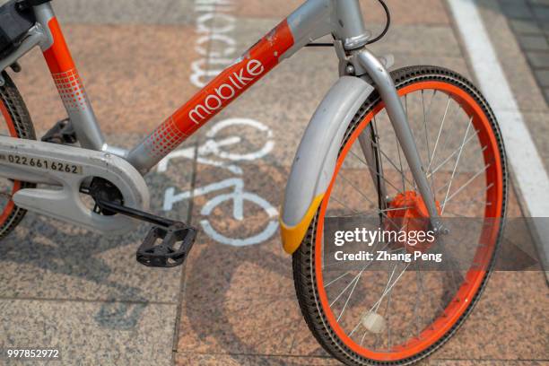 Mobike bicycle stops on the special parking area at roadside. On July 5th, Mobike company announced that all users in China would ride the mobike...