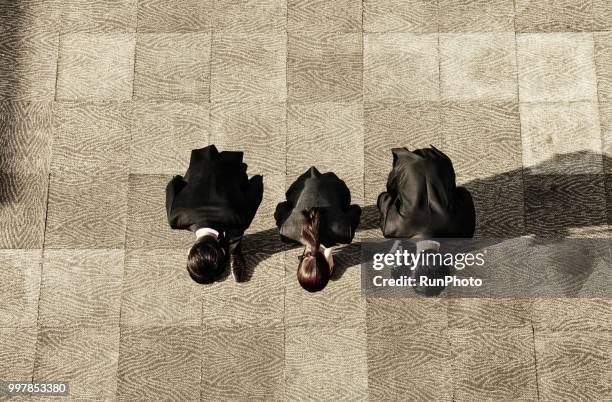 business people bowing to each other - woman bowing stock pictures, royalty-free photos & images