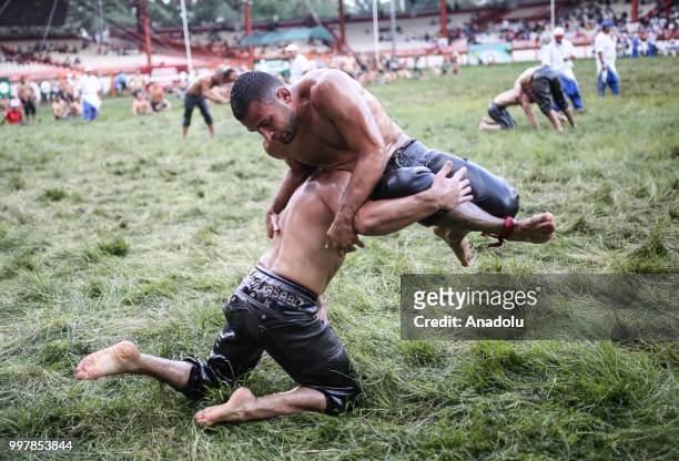 Wrestlers compete against each other on the first day of the 657th annual Kirkpinar Oil Wrestling Festival in Sarayici near Edirne, Turkey on July...