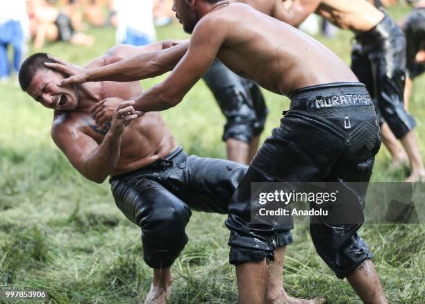 Wrestlers compete against each other on the first day of the 657th annual Kirkpinar Oil Wrestling Festival in Sarayici near Edirne, Turkey on July...