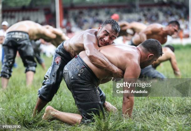 Wrestlers compete against each other on the first day of the 657th annual Kirkpinar Oil Wrestling Festival in Sarayici near Edirne, Turkey on July...