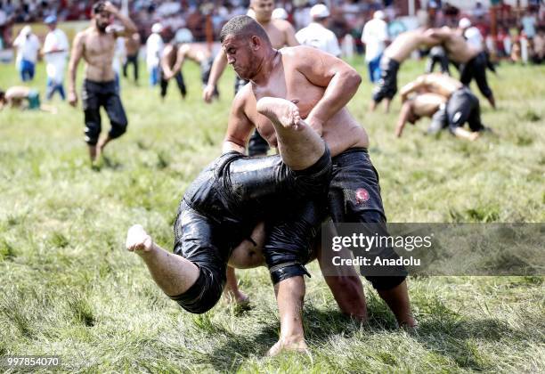 Wrestlers compete against each other on the first day of the 657th annual Kirkpinar Oil Wrestling Festival in Sarayici near Edirne, Turkey on July...