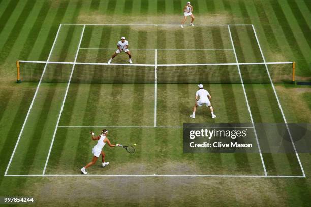 Jamie Murray of Great Britain and Victoria Azarenka of Belarus return against Jay Clarke and Harriet Dart of Great Britain during their Mixed Doubles...