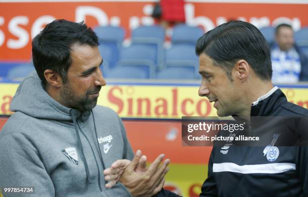 Bochum head coach Ismail Atalan and Duisburg head coach Ilia Gruev greet each other ahead of the 2nd Bundesliga match pitting MSV Duisburg vs VfL...