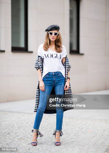 Alexandra Lapp is seen wearing an oversized checkered college jacket from Steffen Schraut, stirrup denim pants from Steffen Schraut, a white V-neck...