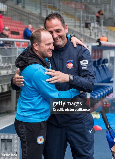 Braunschweig head coach Torsten Lieberknecht and Heidenheim head coach Frank Schmidt converse in the stadium ahead of the 2nd Bundesliga match...