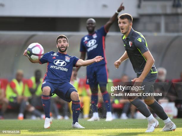 Lyon's French forward Yassin Fekir kicks a ball next to FC Sion's Swiss midfielder Anto Grgicc during the friendly football match between FC Sion and...