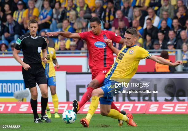 Braunschweig's Gustav Valsvik and Heidenheim's Robert Glatzel vie for the ball during the 2nd Bundesliga match pitting Eintracht Braunschweig vs 1....