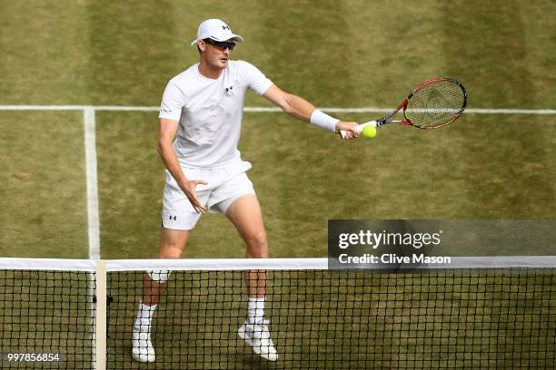 Jamie Murray of Great Britain returns against Jay Clarke and Harriet Dart of Great Britain during his Mixed Doubles semi-final match on day eleven of...