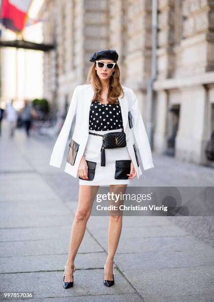 Alexandra Lapp is seen wearing a white Crepe blazer with black leather utility pockets and a white Crepe skirt with black leather utility pockets by...