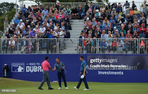 Justin Rose of England and Rickie Fowler of USA and Hideki Matsuyama of Japan finish their round at 18 green during the second day of the Aberdeen...