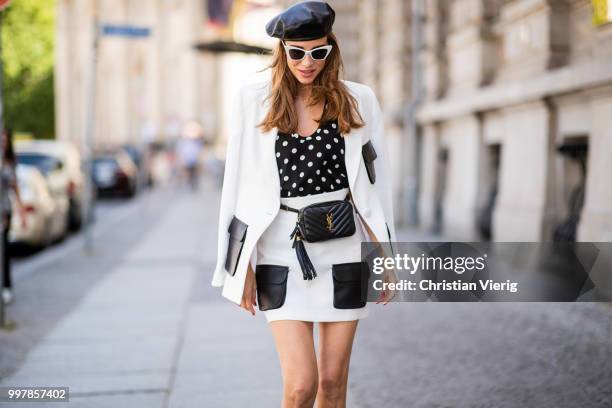 Alexandra Lapp is seen wearing a white Crepe blazer with black leather utility pockets and a white Crepe skirt with black leather utility pockets by...