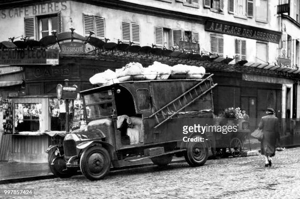Truck is parked in a street of the district of Abbesses, in Paris.