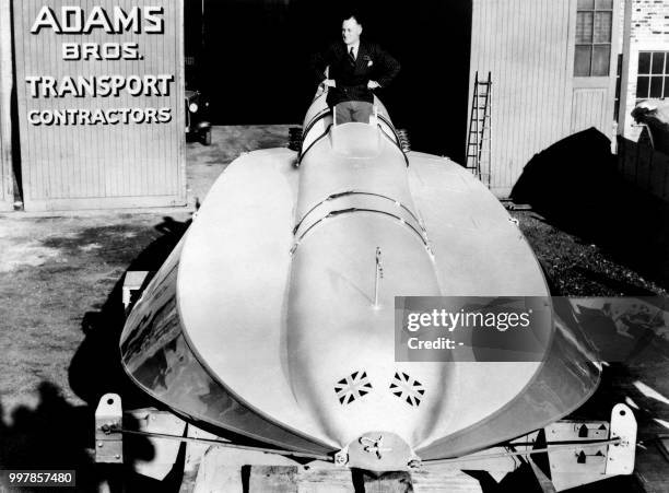 Sir Malcolm Campbell poses on his new motorboat in August 12 in Hourtin, Gironde, France.