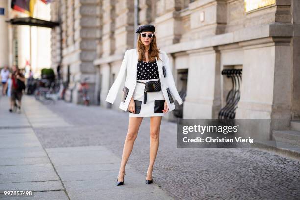 Alexandra Lapp is seen wearing a white Crepe blazer with black leather utility pockets and a white Crepe skirt with black leather utility pockets by...