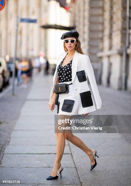 Alexandra Lapp is seen wearing a white Crepe blazer with black leather utility pockets and a white Crepe skirt with black leather utility pockets by...