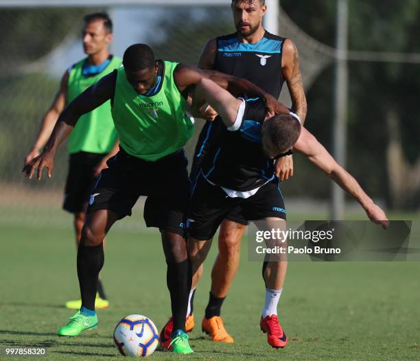 Bartolomeu Bastos and Valon Berisha in action during the SS Lazio training session on July 13, 2018 in Rome, Italy.