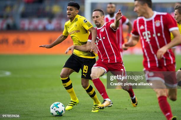 Dortmund's Mahmoud Dahoud and Bayern's Frank Ribery vie for the ball during the FC Bayern Munich vs Borussia Dortmund supercup final in the...