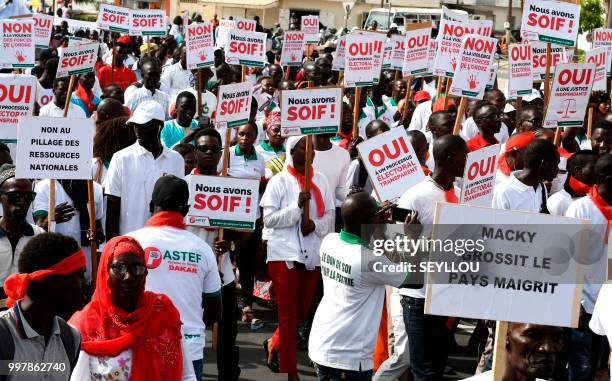 Senegalese opponents protest with placards reading 'We are thirsty' and 'Yes to a transparent electroral process' against the electoral system on...