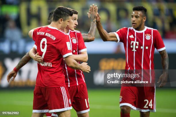 Bayern's scorer Robert Lewandowski , Sebastian Rudy and Corentin Tolisso celebrate the goal during the FC Bayern Munich vs Borussia Dortmund supercup...