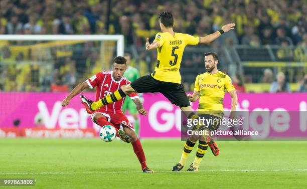 Dortmund's Gonzalo Castro and Marc Bartra vying for the ball with Bayern Munich's Corentin Tolisso during the FC Bayern Munich vs Borussia Dortmund...