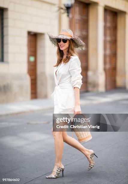 Alexandra Lapp is seen wearing beige striped La Robe Bolso dress by Jacquemus, Maureen leather mules in leo print from Malone Soulless, L'osier sand...