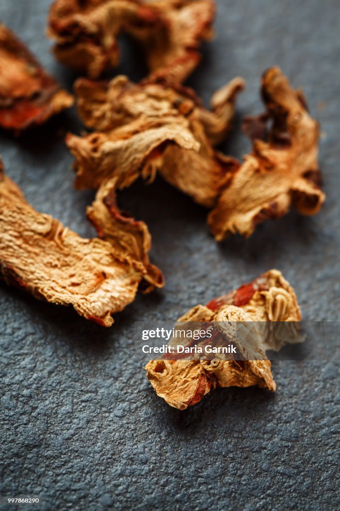 Dried Galangal Root in Close Up on Dark Stone