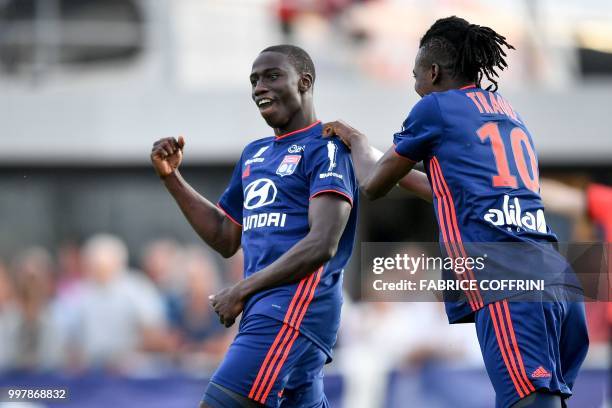 Lyon's French defender Ferland Mendy celebrates after scoring his team's second goal along with his teammate Burkinabe forward Bertrand Traore during...