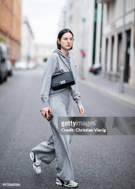 Maria Barteczko is seen wearing sporty grey cashmere hoodie Villao, grey cashmere wide leg pants Villao, logo sneaker Chanel, black bpy bag Chanel,...