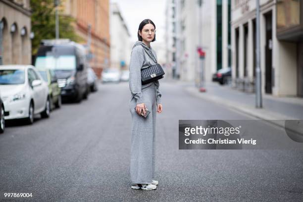 Maria Barteczko is seen wearing sporty grey cashmere hoodie Villao, grey cashmere wide leg pants Villao, logo sneaker Chanel, black bpy bag Chanel,...