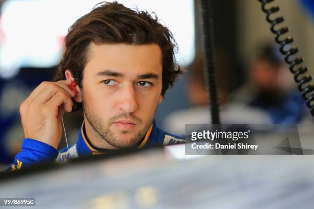 Chase Elliott, driver of the NAPA Auto Parts Chevrolet, stands in the garage area during practice for the Monster Energy NASCAR Cup Series Quaker...