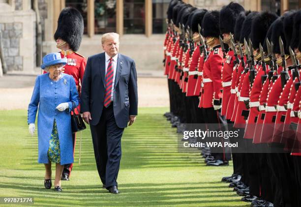 President Donald Trump and Britain's Queen Elizabeth II inspect a Guard of Honour, formed of the Coldstream Guards at Windsor Castle on July 13, 2018...