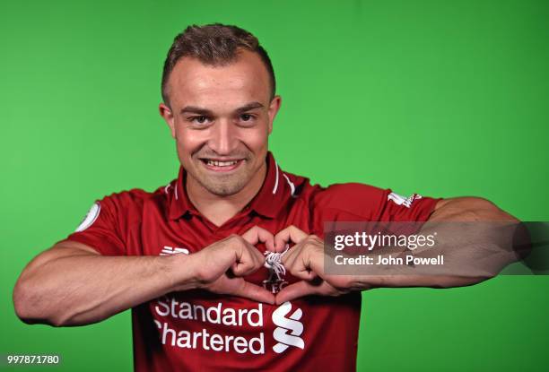 Xherdan Shaqiri signs for Liverpool at Melwood Training Ground on July 13, 2018 in Liverpool, England.