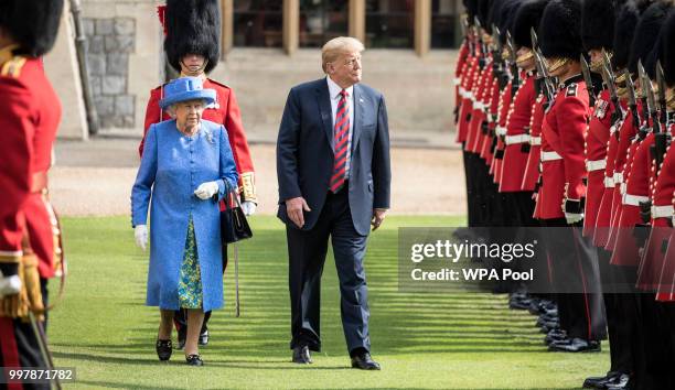 President Donald Trump and Britain's Queen Elizabeth II inspect a Guard of Honour, formed of the Coldstream Guards at Windsor Castle on July 13, 2018...